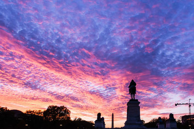 Low angle view of statue against cloudy sky