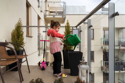 Rear view of young woman standing in city