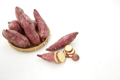 Sweet potato slices against white background