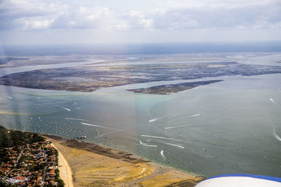 High angle view of sea and landscape against sky