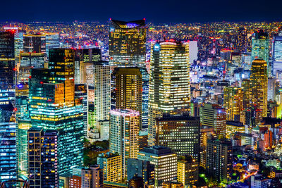 Aerial view of illuminated buildings in city at night