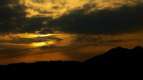 Scenic view of mountains against cloudy sky