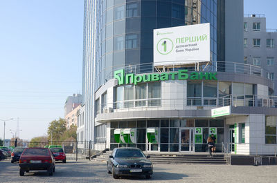 Cars on road against buildings in city