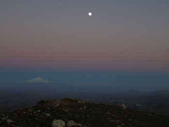 Scenic view of mountains against clear sky at night