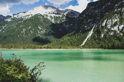 Scenic view of lake and mountains against sky