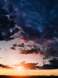 Low angle view of dramatic sky during sunset