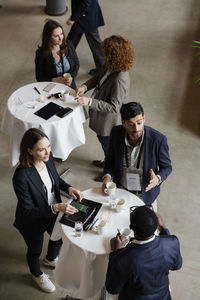 High angle view of business professionals discussing at conference center