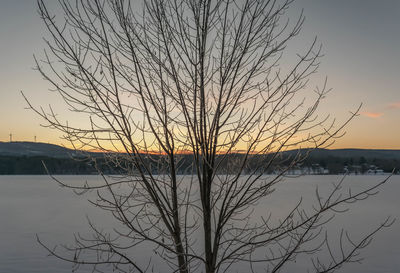 Scenic view of lake against sky at sunset