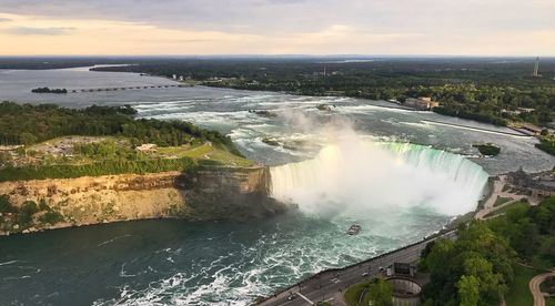 Scenic view of waterfall against sky