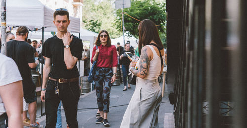 Rear view of people walking in city