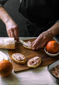 Close-up of person preparing food on cutting board