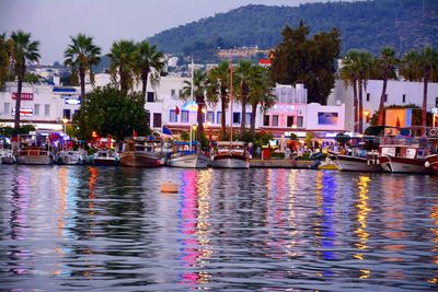 Boats moored on river in town