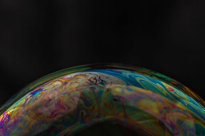 Close-up of bubbles over black background