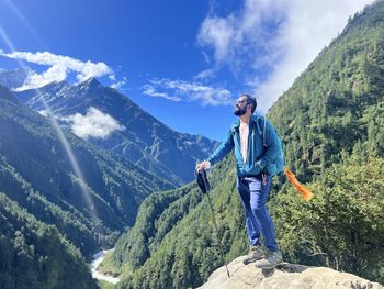 Man standing on mountain against sky