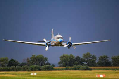Low angle view of airplane flying against clear sky