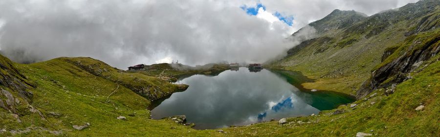 Scenic view of mountains against cloudy sky