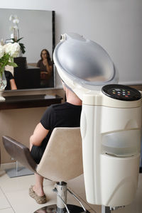 Hair professional treatment in salon. using steam to dilate the pores of scalp. help to combat hair