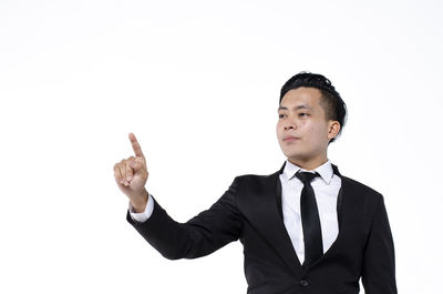 Young man standing against white background