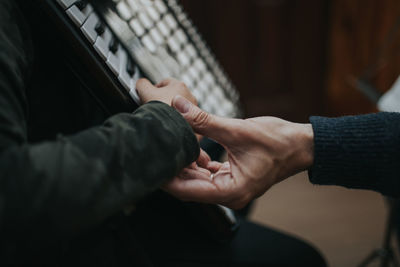 Cropped image of people playing piano