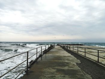 Pier over sea against sky