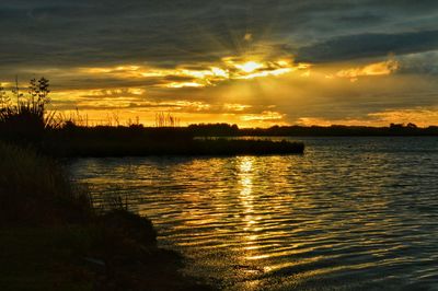 Scenic view of sunset over lake