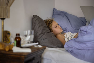 Sick boy lying in bed