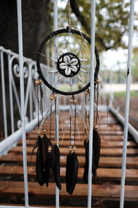 Close-up of electric lamp hanging on metal