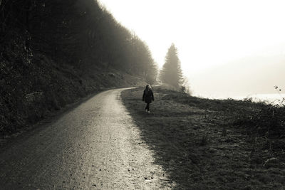 Woman walking on road