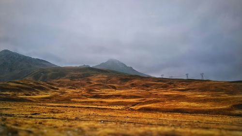 Scenic view of arid landscape against sky