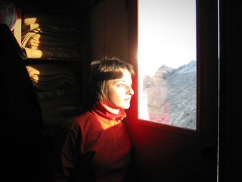 Close-up of woman looking through window