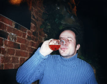 Man drinking beer while sitting at pub