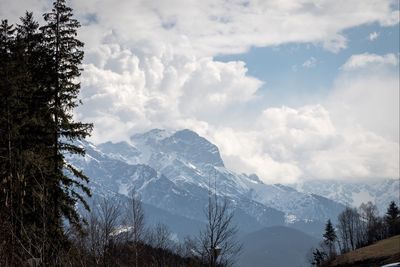 Scenic view of mountains against cloudy sky