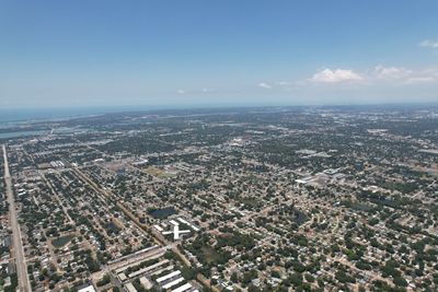 High angle view of city by sea against sky