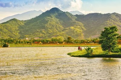 Scenic view of lake and mountains against sky