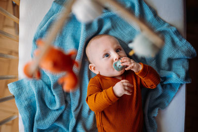 Cute baby lying on bed at home