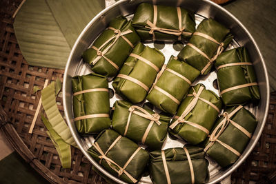 Directly above shot of steam rice wrapped in banana leaves