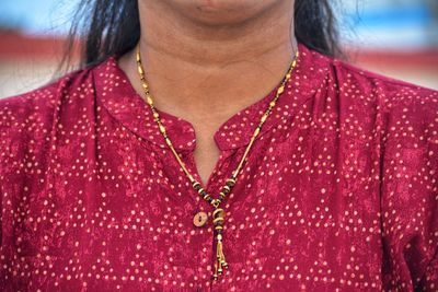 Midsection of woman wearing sweater