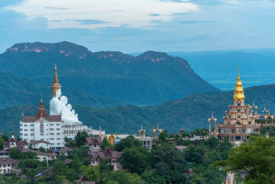 Panoramic view of buildings and mountains against sky