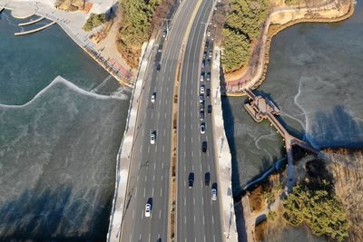 Aerial view of vehicles on bridge over river