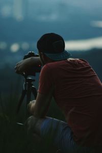 Rear view of man photographing sea