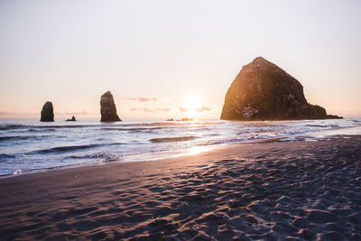 Scenic view of sea against clear sky during sunset