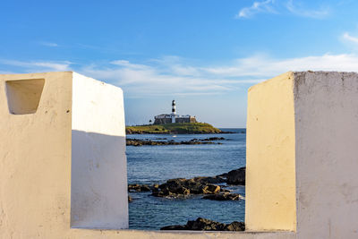 Historic barra lighthouse seen through the walls of the fortress of santa maria in salvador in bahia