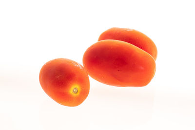 Close-up of orange apple against white background