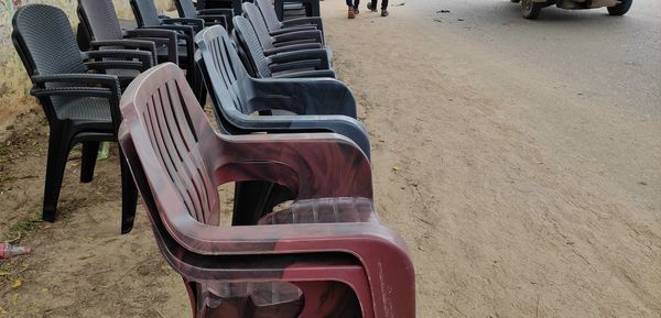 High angle view of empty chairs on beach