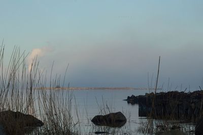 Scenic view of lake against sky at sunset