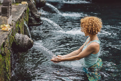 Side view of woman standing in water