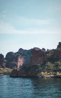 Scenic view of sea and mountains against sky