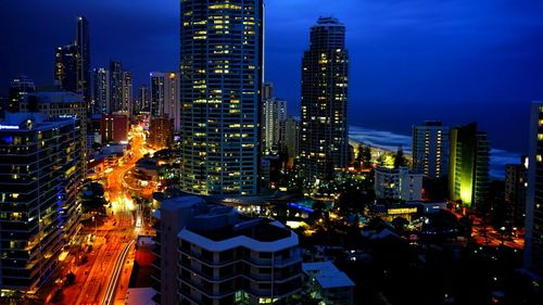 View of skyscrapers lit up at night