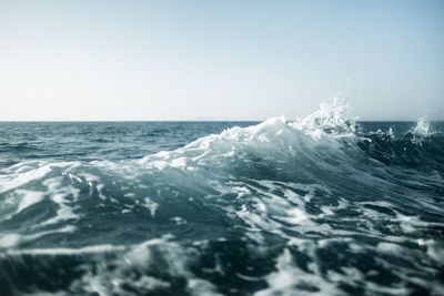 Scenic view of sea waves against clear sky