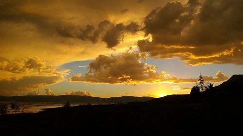 Scenic view of silhouette mountains against sky during sunset